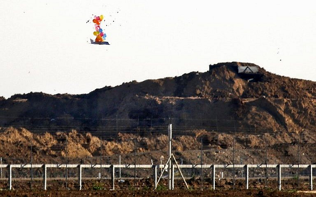 this picture from march 22 2019 shows balloons carrying a make shift drone shaped object flying over the border with israel east of gaza city after it was launched by palestinians during clashes along the security fence photo afp