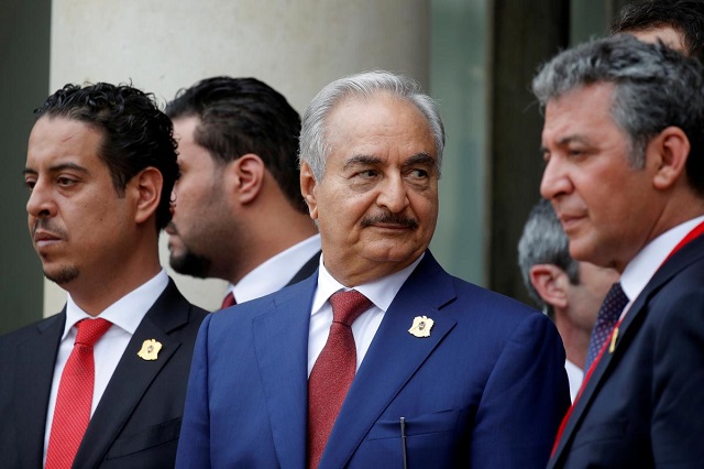 khalifa haftar c the military commander who dominates eastern libya leaves after an international conference on libya at the elysee palace in paris france may 29 2018 photo reuters