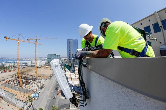 telecommunications workers chris viens and guy glover install a new 5g antenna system for at amp t 039 s 5g wireless network in downtown san diego california us april 23 2019 photo reuters