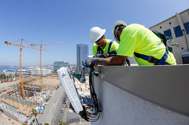 telecommunications workers chris viens and guy glover install a new 5g antenna system for at amp t 039 s 5g wireless network in downtown san diego california us april 23 2019 photo reuters