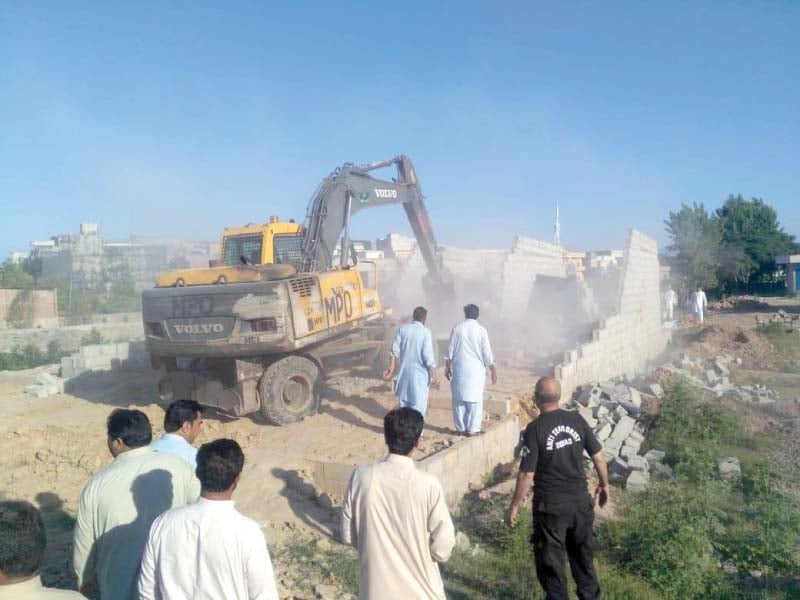 cda officials tear down an illegal structure on saturday photo express