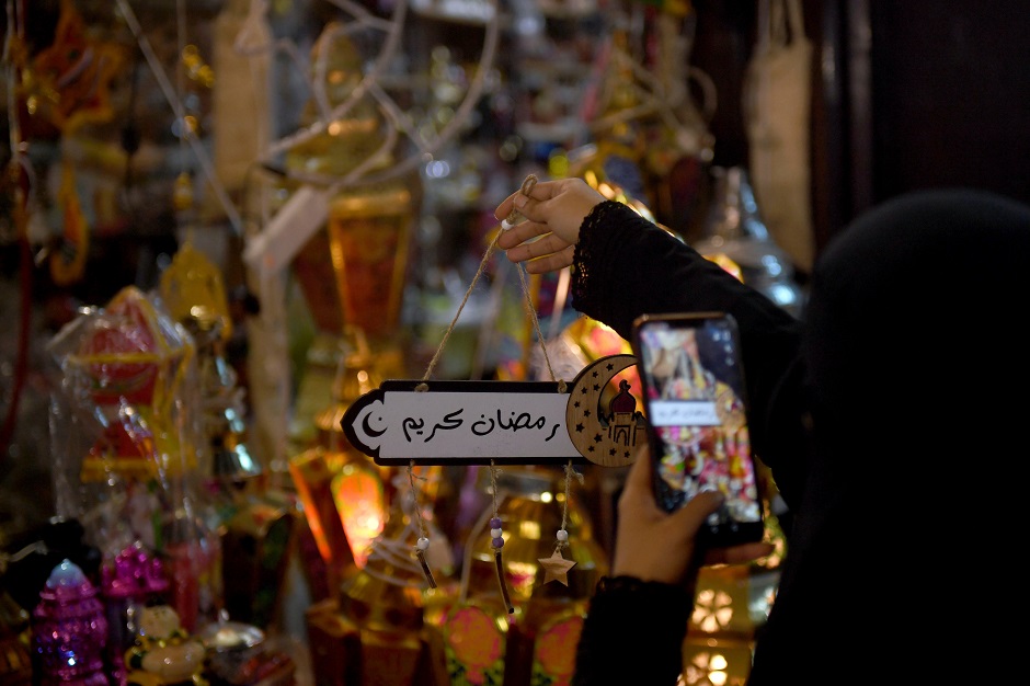 7 a saudi woman takes a picture of decorations in the saudi coastal city of jeddah ahead of the muslim holy fasting month of ramadan photo afp