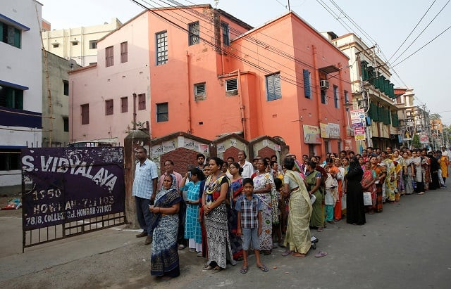 people stand in a queue to cast their vote outside a polling station during the fifth phase of general election in howrah on the outskirts of kolkata india photo reuters