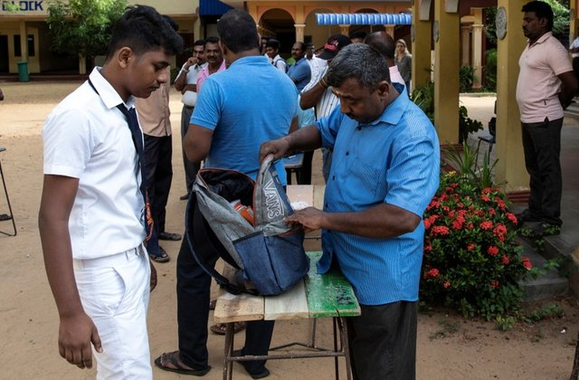 a student 039 s bag is searched by a parent as he arrives at his school which opened days after a string of suicide bomb attacks across the island on easter sunday in batticaloa sri lanka may 6 2019 photo reuters