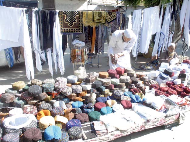 a view of a sasta bazaar set up in rawalpindi to facilitate residents and a vendor sells caps and scarves on a roadside in rawalpindi photos online