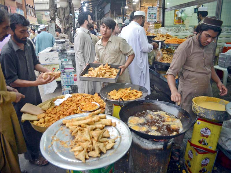 vendors frying iftar items in a market in peshawar where price of cooking oil has increased with the advent of ramazan photo ppi