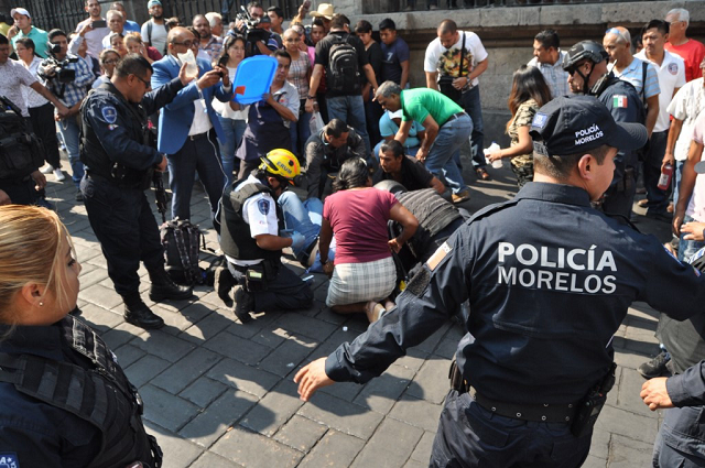 an injured man receives first aid after a gunman opened fire in the central square of cuernavaca morelos state in mexico on may 8 2019 photo afp