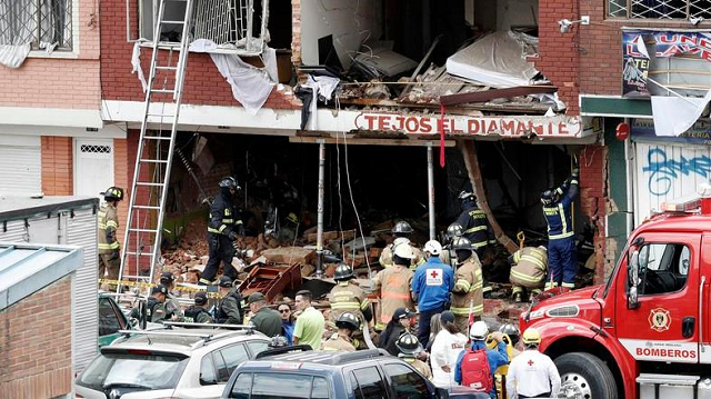 fire fighters and rescue workers inspect the damage at a factory in bogota where an explosion killed four people and left 29 injured photo afp