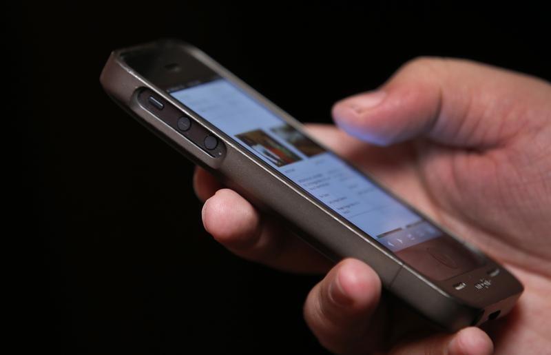 a man uses a smartphone photo reuters