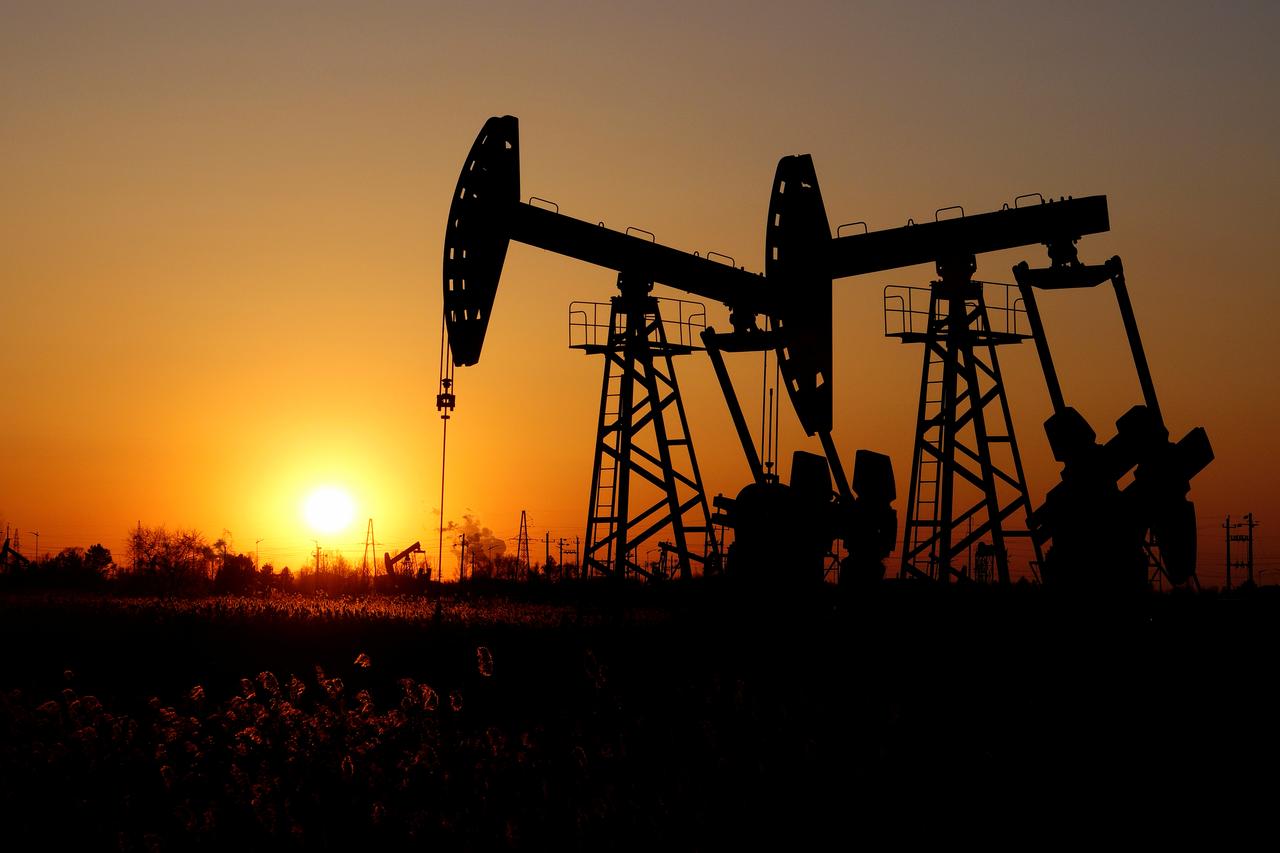 pumpjacks are seen against the setting sun photo reuters