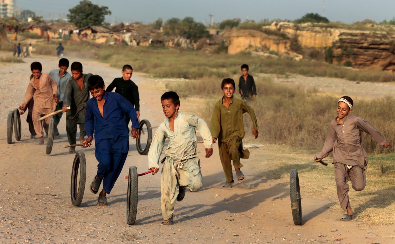 children play with tyres in islamabad pakistan photo reuters