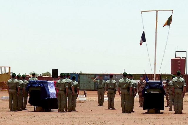 french soldiers of the counter terrorism barkhane mission in africa 039 s sahel region standing guard by the coffins of their comrades during a funeral cerenomy at their base camp in northern burkina faso on may 13 2019 photo afp