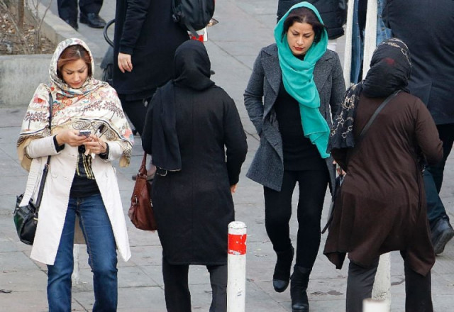 a file picture taken on february 7 2018 shows iranian women wearing hijab walk down a street in the capital tehran photo afp