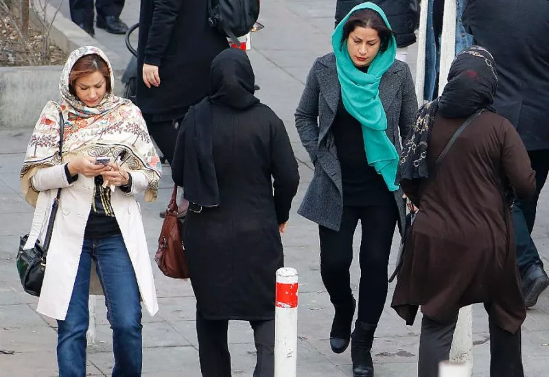 a file picture taken on february 7 2018 shows iranian women wearing hijab walk down a street in the capital tehran photo afp