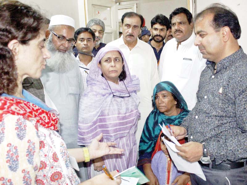 dr azra pechuho enquires about the health of patients during her visit to chandka medical college hospital in larkana on tuesday photo ppi