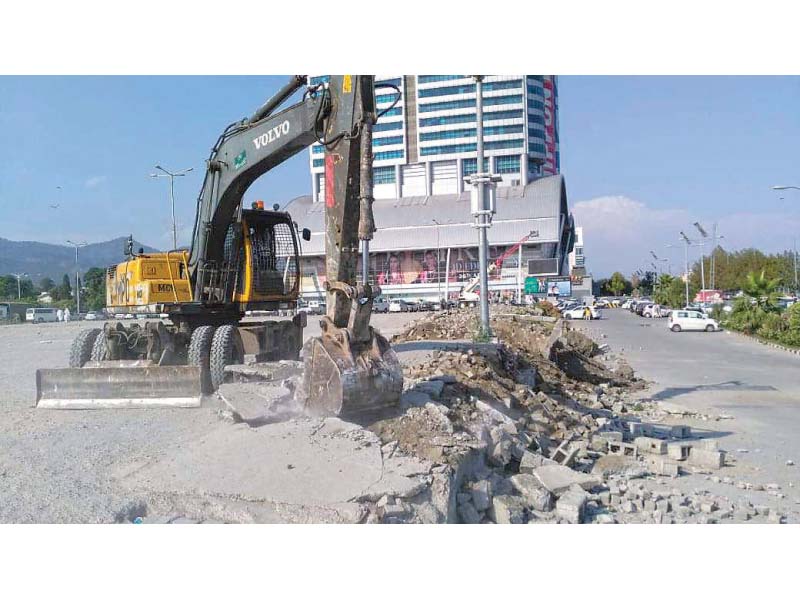 metropolitan workers use heavy machinery to remove encroachments in the area photos express