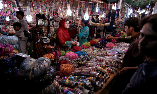 a woman buy bangles and jewellery at a stall ahead of eid al fitr in islamabad photo reuters