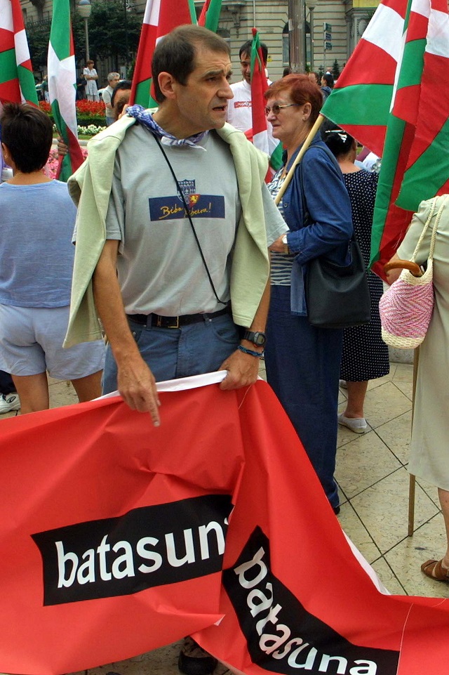 this file photo taken on august 23 2002 shows former eta activist and pro independence basque nationalist party batasuna regional parliament 039 s deputy jose antonio urrutikoetxea alias quot josu ternera quot holding a banner with the name of his party during a demonstration against the expected illegalisation of batasuna in the spanish northern basque city of bilbao photo afp file
