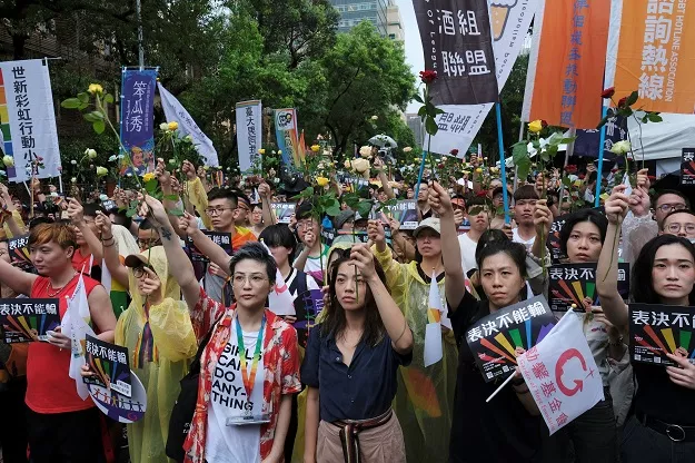 same sex marriage supporters hold roses to mourn those who committed suicide due to discrimination during a parliament vote on three draft bills of a same sex marriage law outside the legislative yuan in taipei photo reuters same sex marriage supporters hold roses to mourn those who committed suicide due to discrimination during a parliament vote on three draft bills of a same sex marriage law outside the legislative yuan in taipei photo reuters