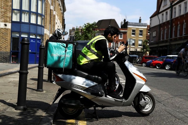 a deliveroo scooter driver takes a break between deliveries in london britain june 8 2018 photo reuters