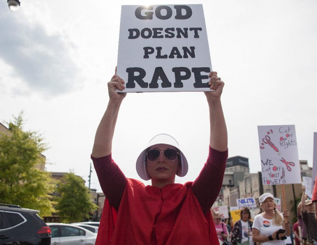 some of the protesters in montgomery alabama dressed as characters forced to bear children of rape in the dystopian novel and television series quot the handmaid 039 s tale quot photo afp