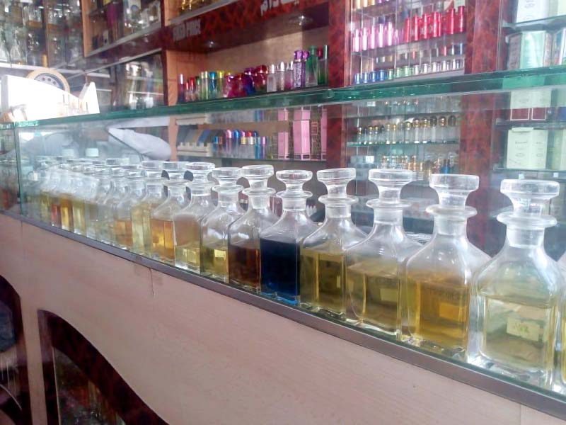 glass bottles with an exotic and admirable look used to store and sell attar in are displayed at a shop in botal gali photo express