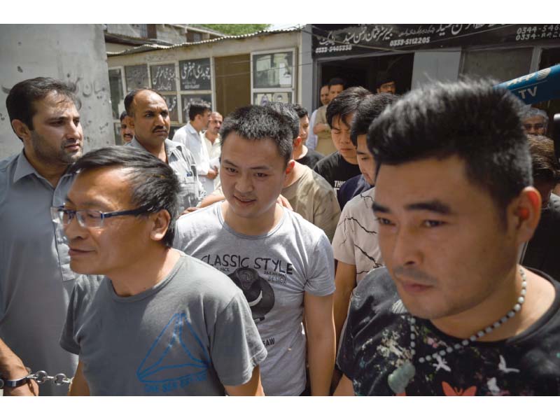 chinese nationals arrive at a court in islamabad after being arrested by the fia for their alleged involvement in a trafficking ring to lure women from pakistan into fake marriages and then forcing them into prostitution in china photo file afp