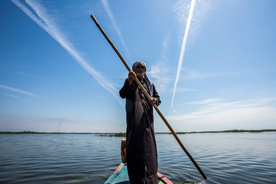 1 abu hayder an iraqi ecotourism guide navigates a canoe in the marshes of the southern district of chibayish in dhi qar province about 120 kilometres northwest of the southern city of basra photo afp