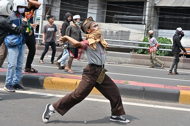 protesters hurl rocks toward police during a clash in jakarta on may 22 2019 photo afp protesters hurl rocks toward police during a clash in jakarta on may 22 2019 photo afp