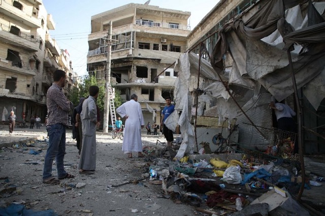 maarat al numan residents survey the remains of stalls in the town 039 s market after it was hit by suspected syrian government air strikes that killed 12 civilians the previous evening photo afp