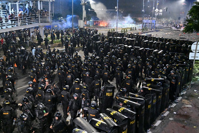 riot police stand guard during a demonstration against the re election of indonesian president in jakarta on may 22 2019 photo afp