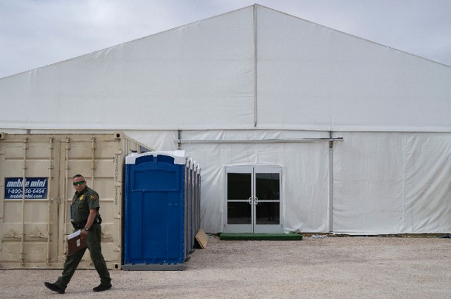 a us border patrol agent walks by a new temporary holding facility opened by customs and border protection personnel on the us mexico border in el paso texas photo afp a us border patrol agent walks by a new temporary holding facility opened by customs and border protection personnel on the us mexico border in el paso texas photo afp
