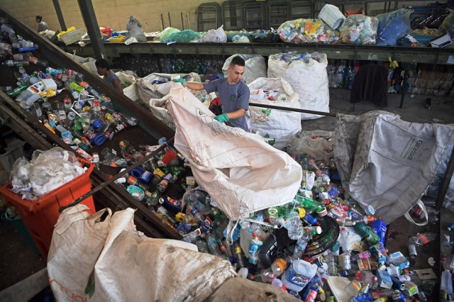 a worker loads plastics onto a conveyor belt at coopfuturo a sorting collective which receives rubbish from the local government collection service and then sells the material to specialized recycling companies in rio de janeiro brazil photo afp