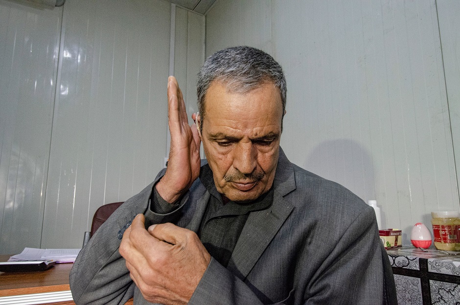 an iraqi deaf patient tests his hearing aid at jumhuri hospital a specialised hearing impairment centre in west iraq 039 s city mosul photo afp