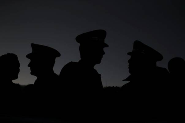 a reuters file photo of police officials silhouetted