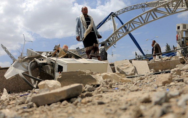 men inspect a damaged petrol station after it was hit by a previous alleged saudi led coalition airstrike on the outskirts the yemeni capital sanaa on may 21 2018 photo afp