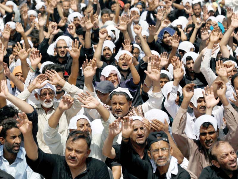 mourners raise their hands and shout slogans during a procession on youm e ali in karachi the day marks the martyrdom of hazrat ali ibn abu talib ra photo reuters