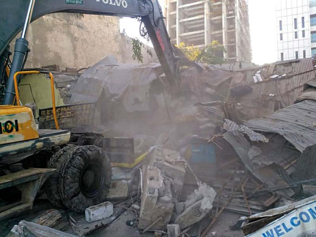 an excavator tears down illegal construction photo express an excavator tears down illegal construction photo express