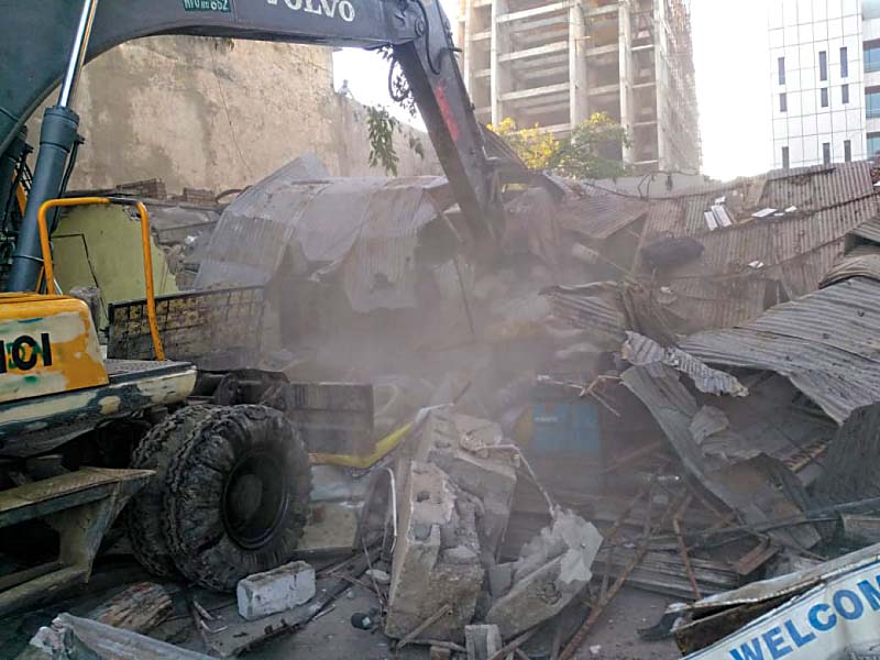 an excavator tears down illegal construction photo express