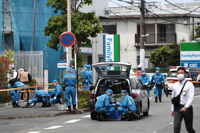 police forensic experts are seen at the crime scene where a man stabbed 19 people including children in kawasaki photo afp