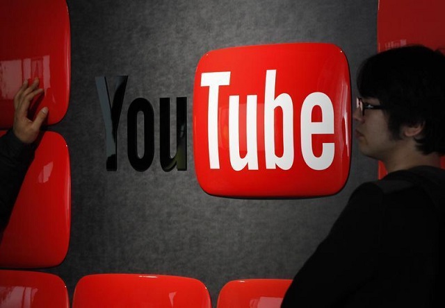 visitors stand in front of a logo of youtube at the youtube space tokyo operated by google in tokyo february 14 2013 photo reuters