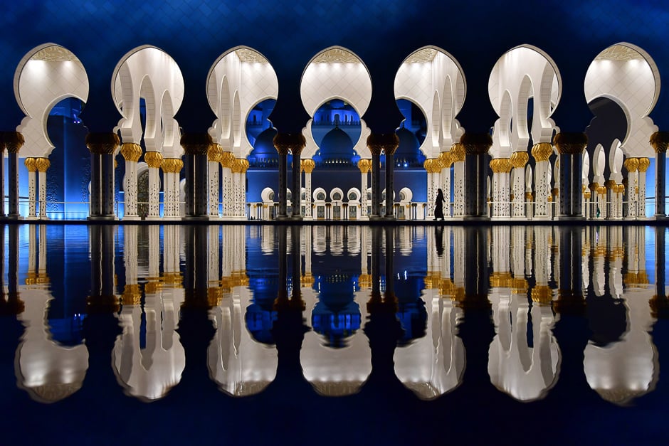 visitors walk in the courtyard of the sheikh zayed grand mosque in the uae capital abu dhabi photo afp