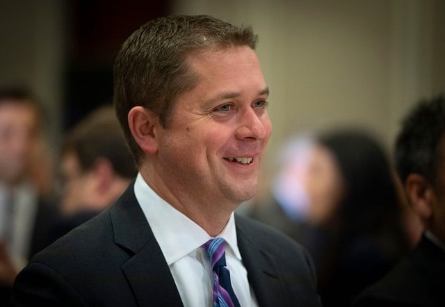 in this file photo taken on may 07 2019 andrew scheer leader of the conservative party of canada smiles during an event at the montreal council on foreign relations mcfr at the marriott chateau champlain in montreal   canada 039 s conservative party chief and opposition leader andrew scheer said may 28 2019 he wants to end illegal border crossings from the united states by revisiting the two countries 039 refugee agreement quot we will work to put an end to the illegal border crossings at unofficial points of entry like roxham road by closing the loophole in the safe third country agreement that allows some people to skip the line and avoid the queue quot he said photo afp