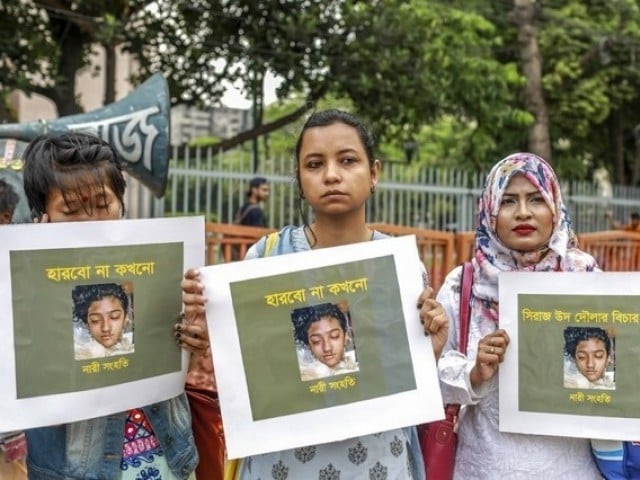 in this photo taken on april 12 2019 bangladeshi women hold placards and photographs of schoolgirl nusrat jahan rafi at a protest in dhaka following her murder by being set on fire after she had reported a sexual assault   a schoolgirl was burned to death in bangladesh on the orders of her head teacher after she reported him for sexually harassing her police said april 19 the death of 19 year old nusrat jahan rafi last week sparked protests across the south asian nation with the prime minister promising to prosecute all those involved photo afp file
