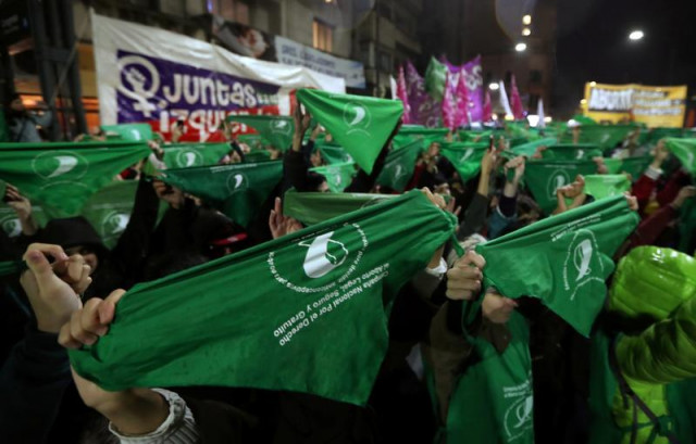 demonstrators hold up green handkerchiefs during a demonstration in favor of legalising abortion outside the congress in buenos aires argentina photo reuters demonstrators hold up green handkerchiefs during a demonstration in favor of legalising abortion outside the congress in buenos aires argentina photo reuters