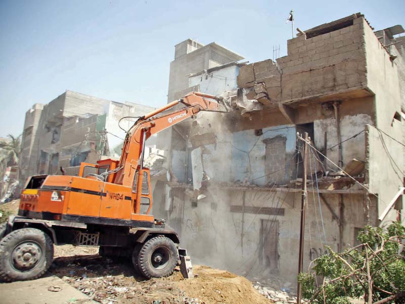 kmc with the help of heavy machinery bulldozed around 100 concrete houses within 50 feet of the kcr track from gujjar nullah to nazimabad some of the affected residents started to demolish the illegal constructions themselves photo ppi