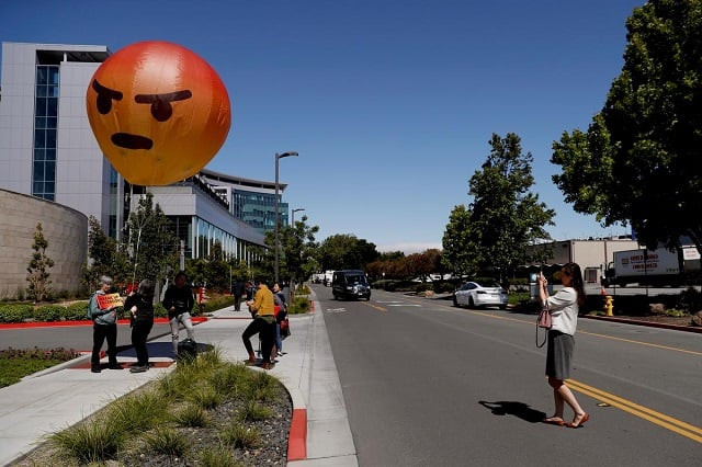 a passerby takes a photograph of an inflatable angry emoji during a protest outside the facebook 2019 annual shareholder meeting in menlo park california us may 30 2019 photo reuters a passerby takes a photograph of an inflatable angry emoji during a protest outside the facebook 2019 annual shareholder meeting in menlo park california us may 30 2019 photo reuters