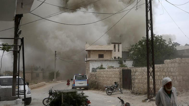 syrians run for cover during an air strike by pro regime forces on the market town of kfar ruma in syria s southwestern idlib province on may 30 2019 photo afp