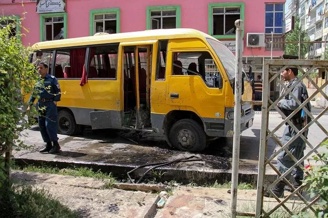 afghan security personnel stand near the a damage bus carrying university students at the site of the successive bomb blasts in kabul photo afp afghan security personnel stand near the a damage bus carrying university students at the site of the successive bomb blasts in kabul photo afp