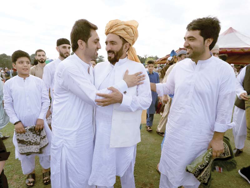 men greet one another after eidul fitr prayers to mark the end of the holy month of ramazan in peshawar photo reuters